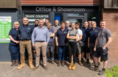 A photo of the Shoptek team standing in front of the company premises