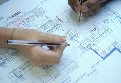 A photo of Shoptek employee describing a shop fit-out plan